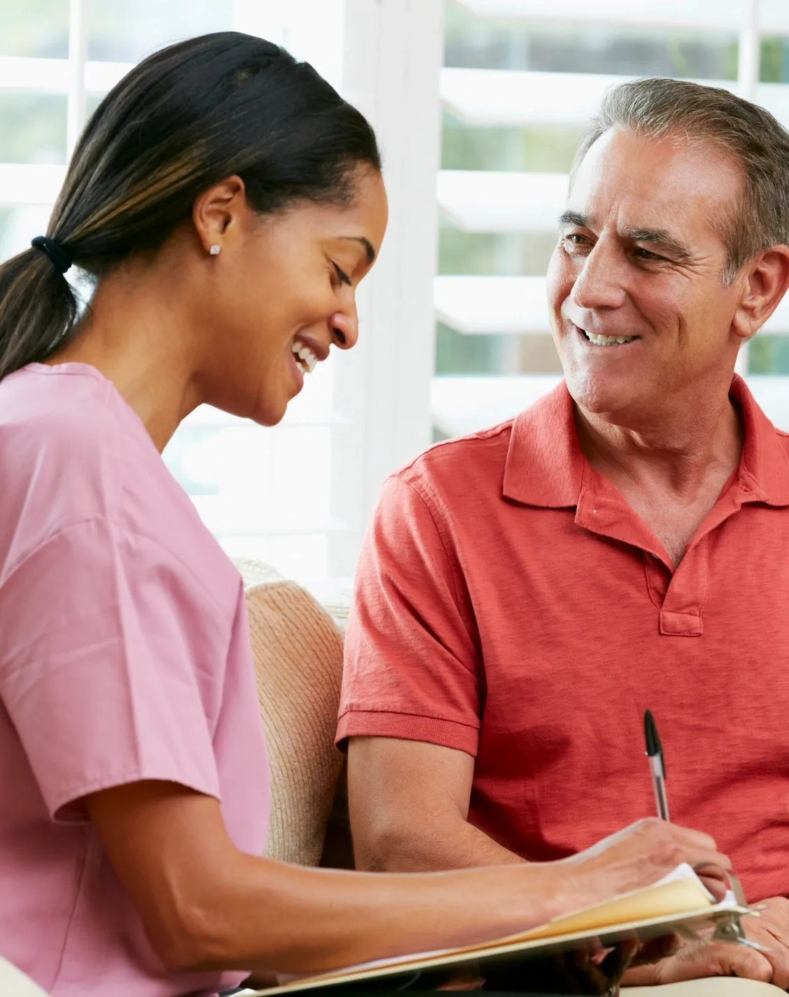 Caregiver Taking Records Male Patient zoom in