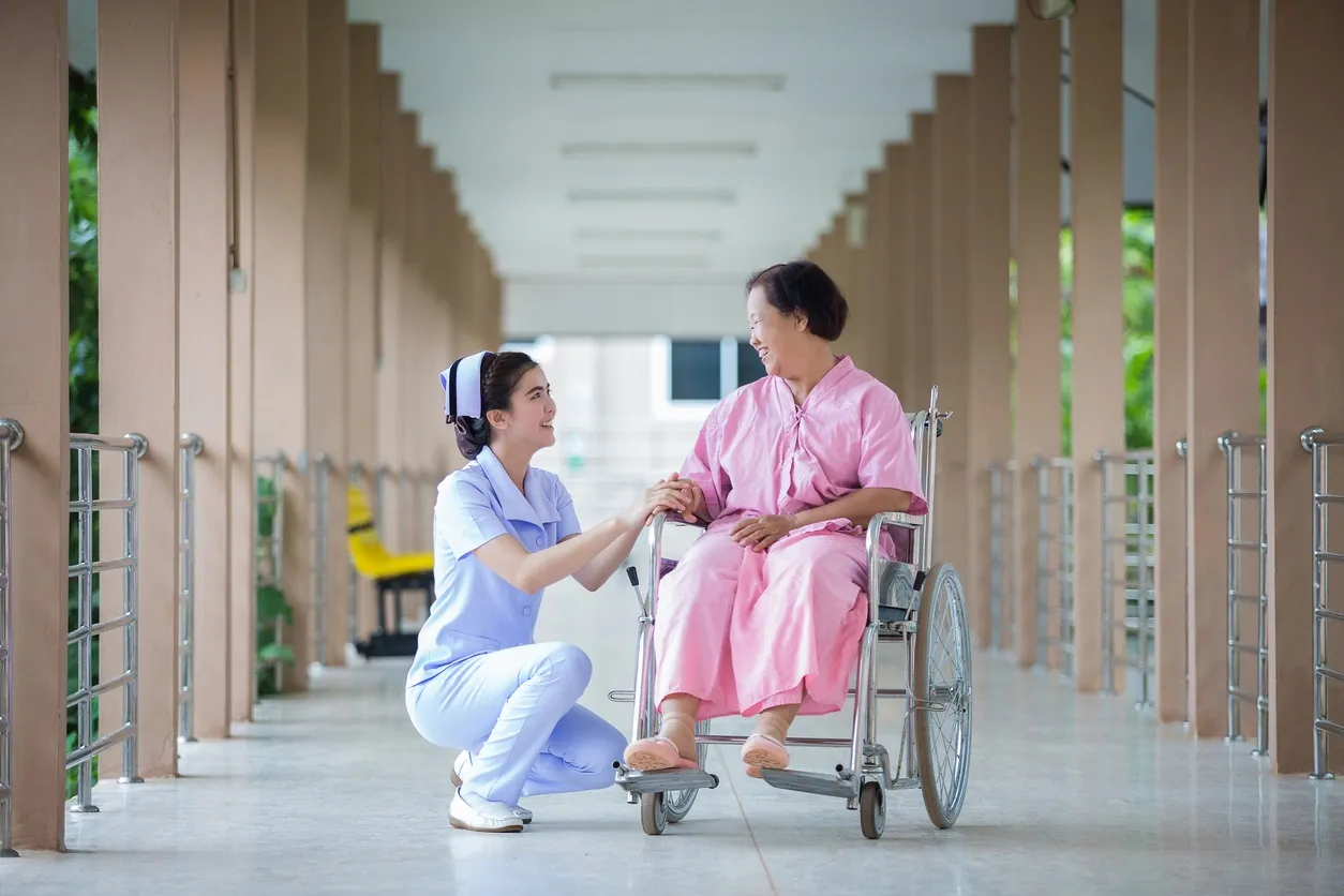 Nurse with Asian Patient On Wheelchair